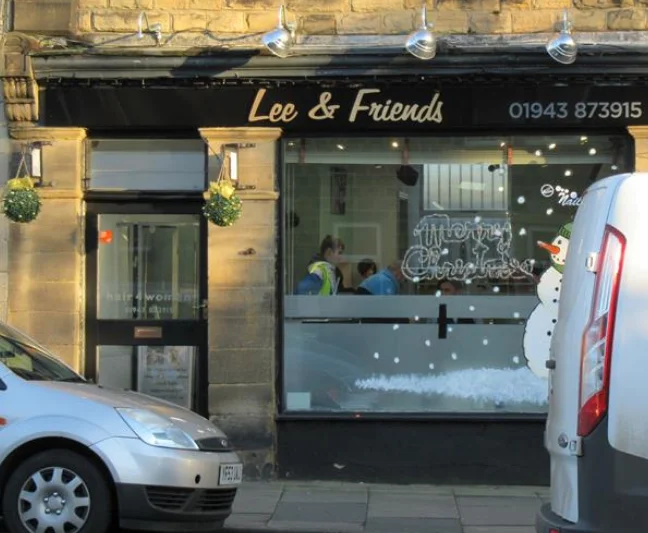 Lee and Friends stone shopfront with its gold handwritten sign at 14 Town Gate